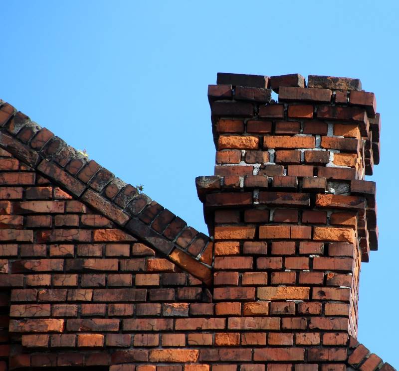 Damaged chimney on an Universal City home showing cracks and missing mortar